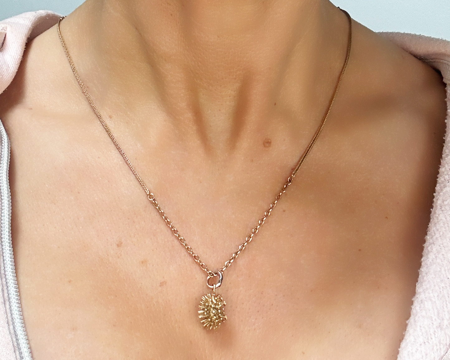 woman wearing gold hedgehog chain