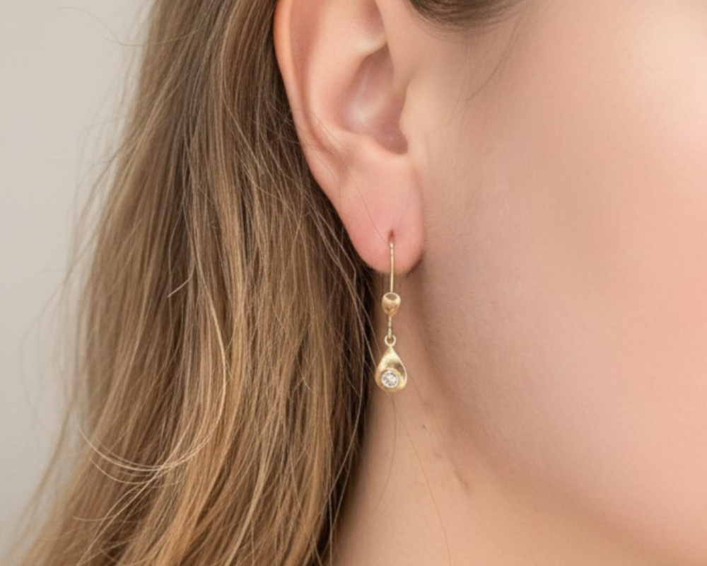 vintage 18ct gold and diamond drop earrings for sale in Leeds, shown on a model's earr
