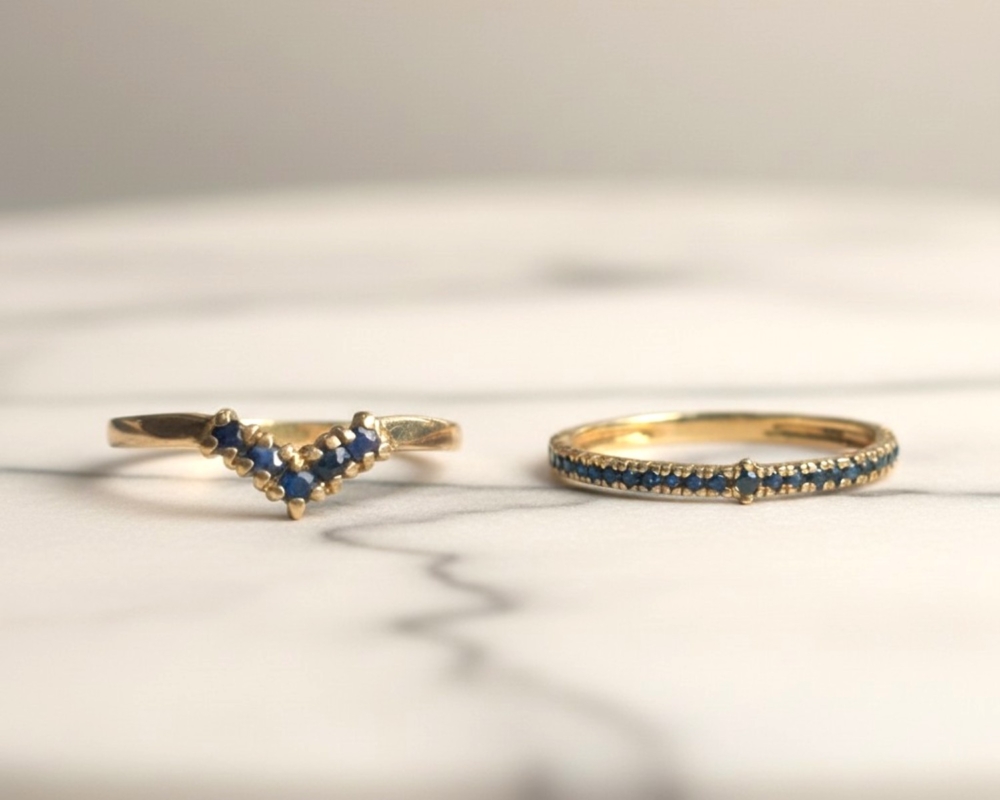 vintage sapphire stacking set in 9ct yellow gold for sale in Leeds, on a marble background