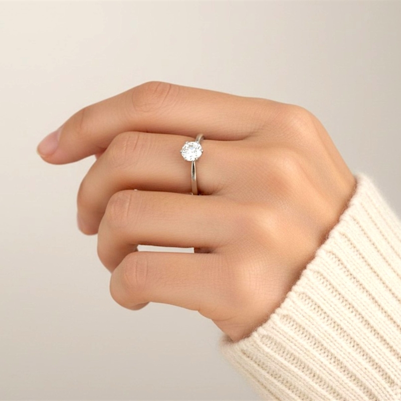 vintage diamond solitaire ring with 0.56ct VS1 clarity and D colour in platinum for sale in Leeds, UK, shown on a models' finger