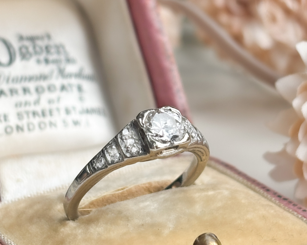 Antique Art Deco stepped diamond ring in platinum for sale in Leeds, shown displayed in a pink box