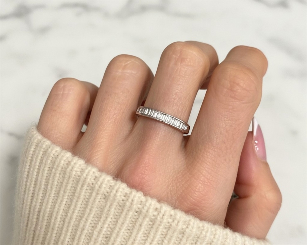 pre-owned baguette diamond half eternity ring in 18ct white gold for sale in Leeds on model's hand