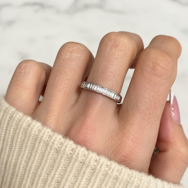 pre-owned baguette diamond half eternity ring in 18ct white gold for sale in Leeds on model's hand
