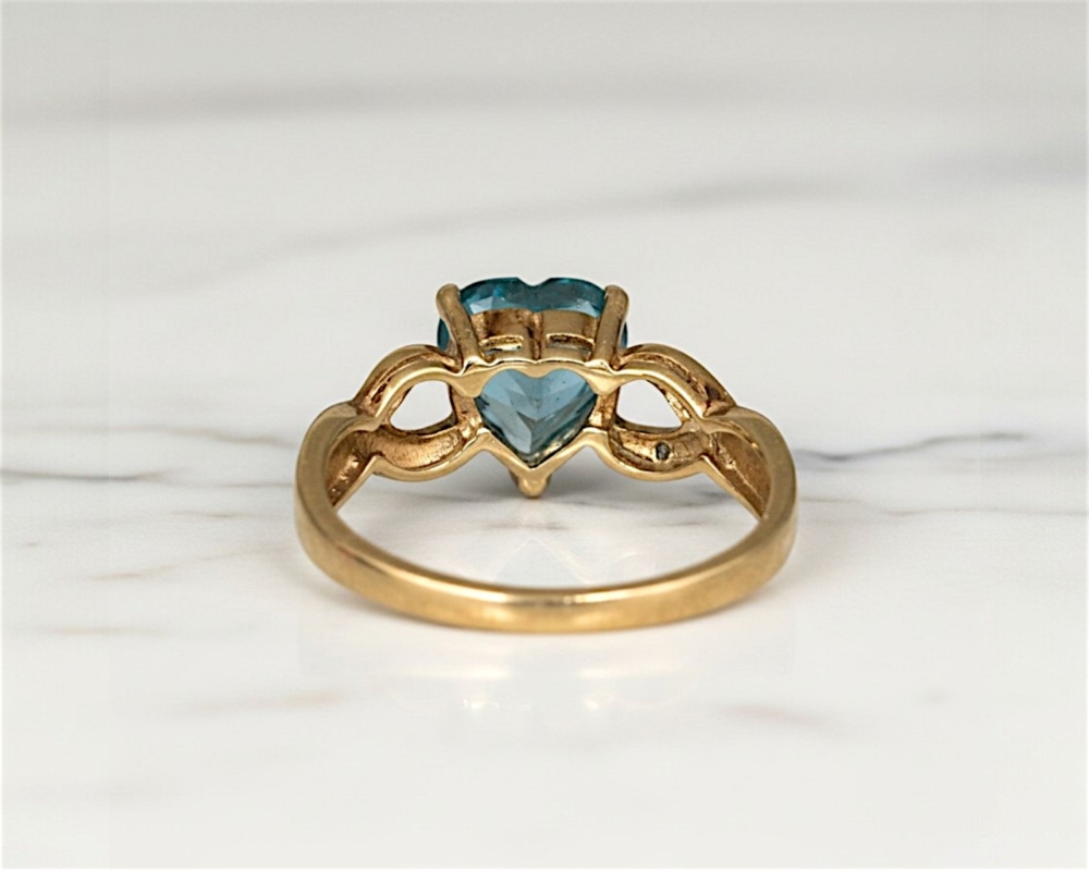 vintage blue topaz heart ring in 9ct gold with diamonds. For sale in Leeds, UK, back profile view