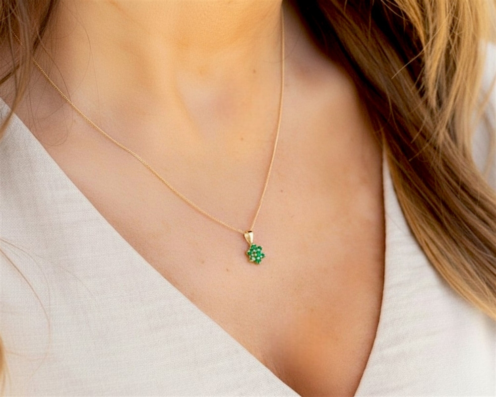 vintage style 9ct gold and emerald cluster pendant on a gold chain for sale in Leeds on model