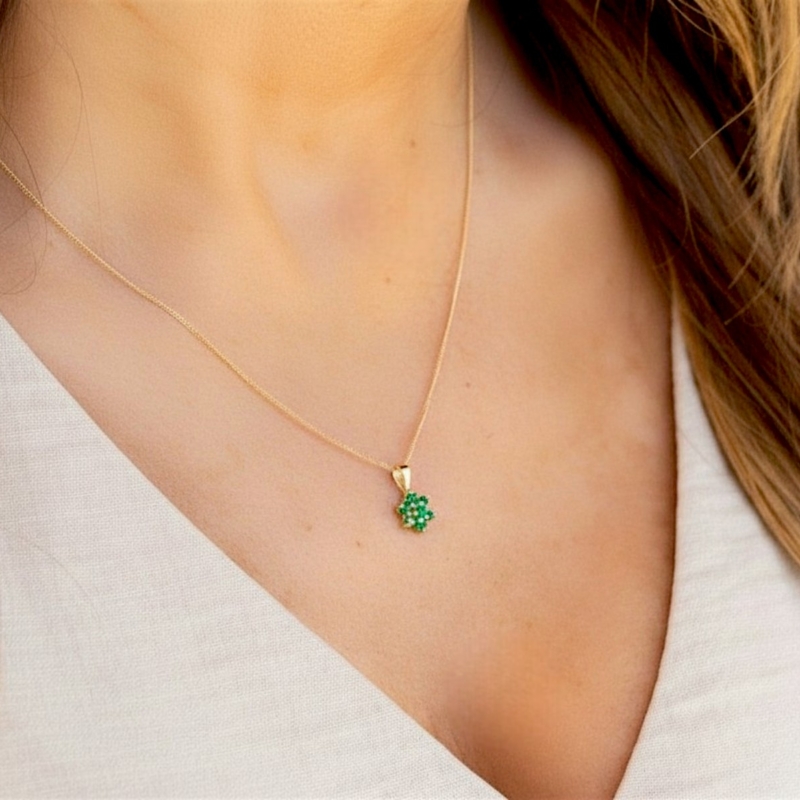 vintage style 9ct gold and emerald cluster pendant on a gold chain for sale in Leeds on model