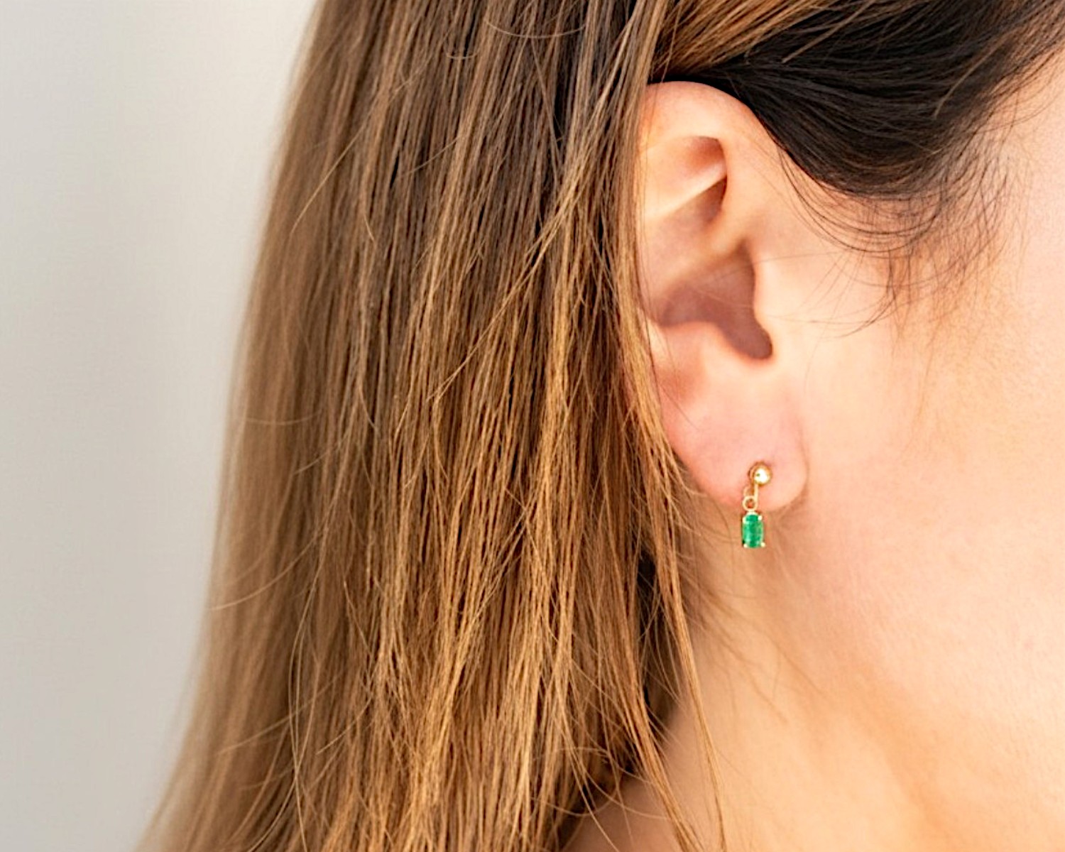 emerald studs on ear