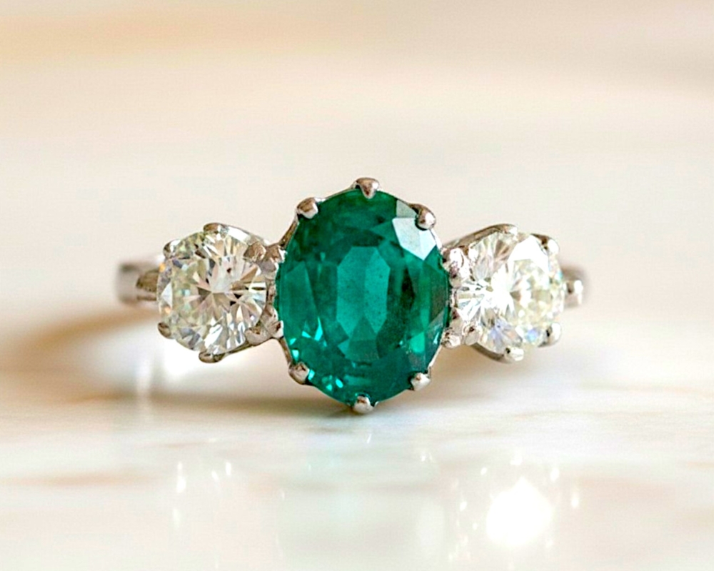 vintage style emerald and diamond three stone ring in platinum for sale in Leeds, Uk, showing side view
