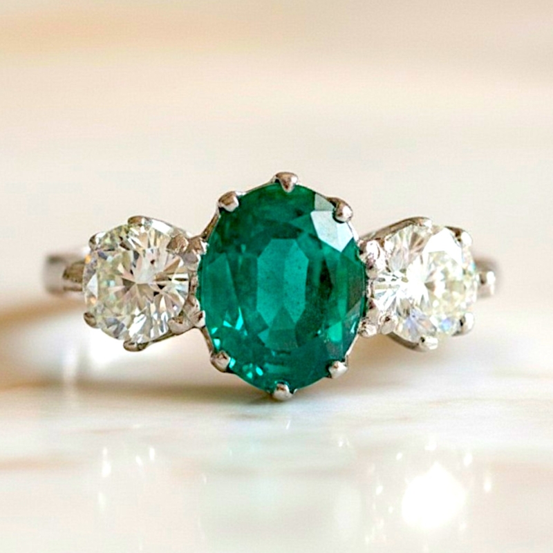 vintage style emerald and diamond three stone ring in platinum for sale in Leeds, Uk, showing side view