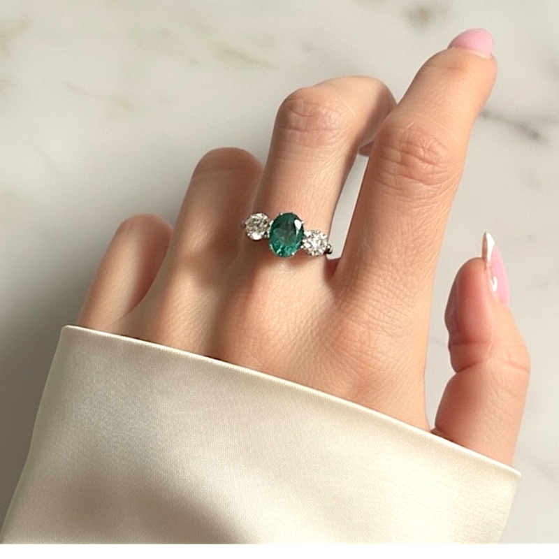 vintage style emerald and diamond three stone ring in platinum for sale in Leeds, Uk, on model's hand