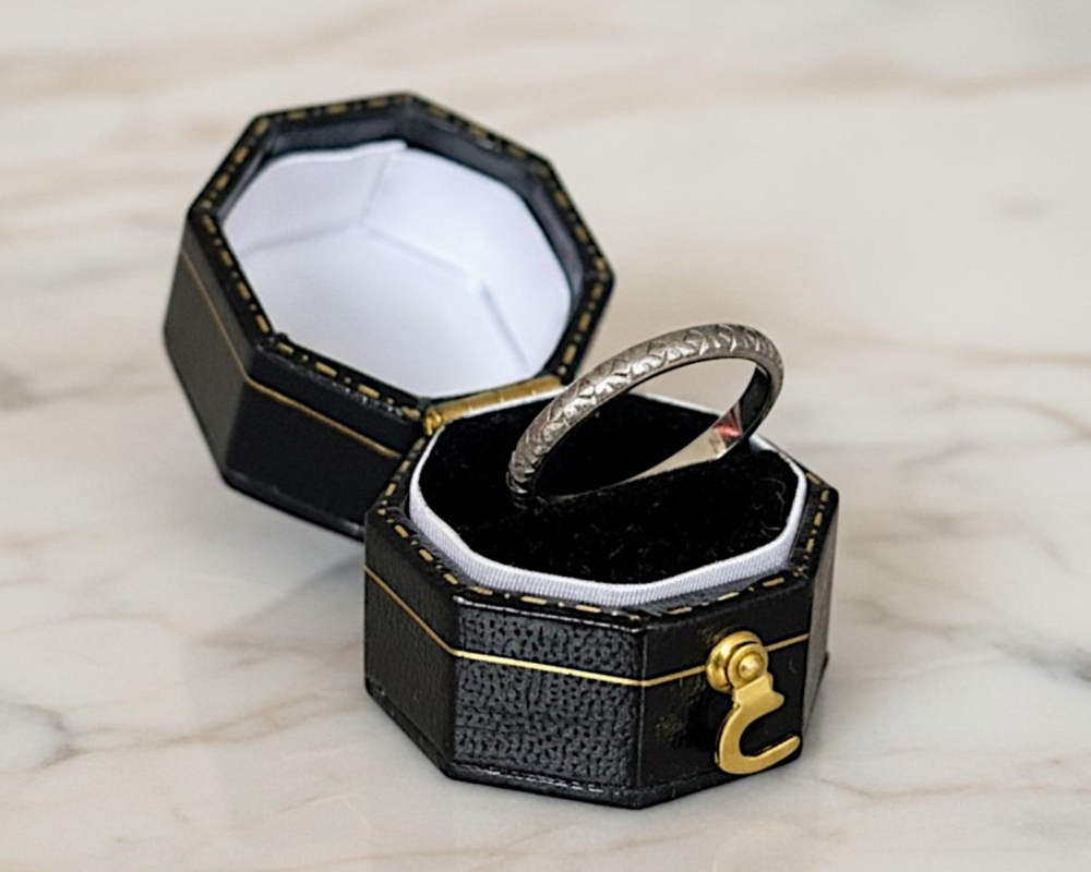 antique 1930s platinum engraved wedding ring for sale in Leeds, UK, shown here in a box