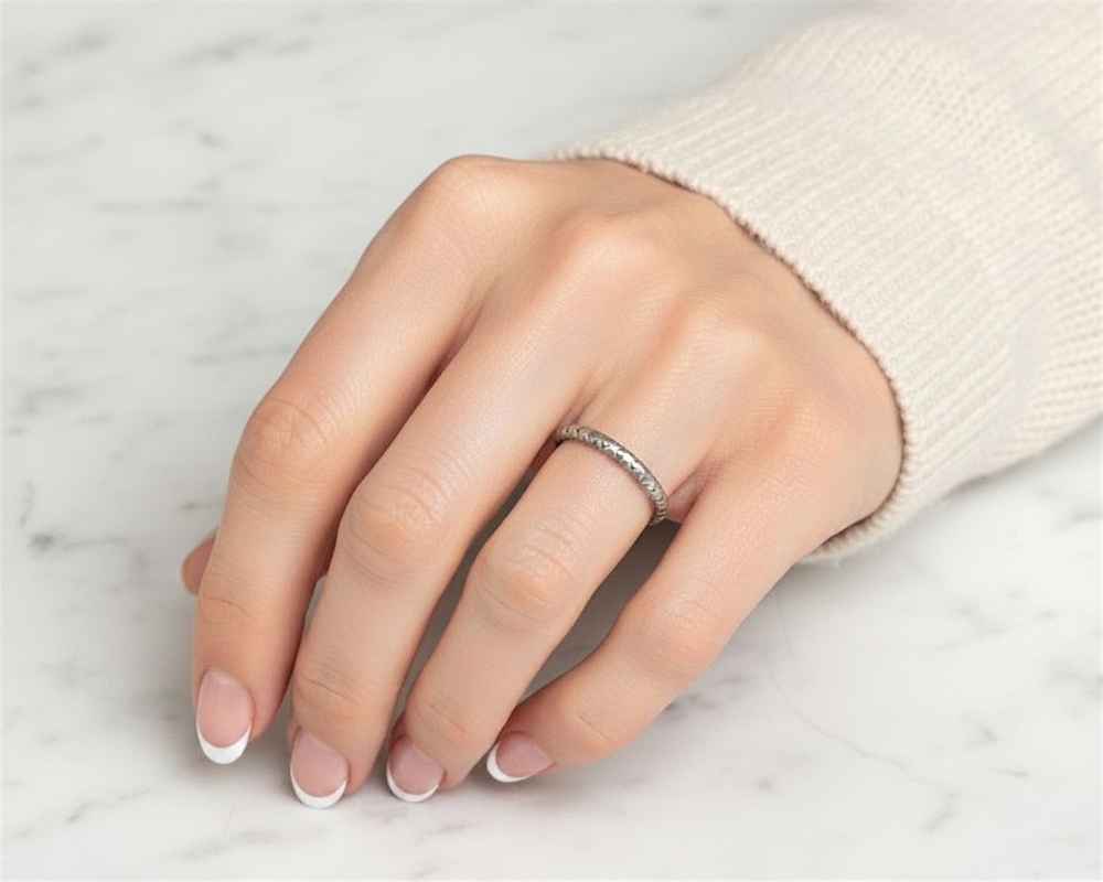 antique 1930s platinum engraved wedding ring for sale in Leeds, UK shown here on a model's hand