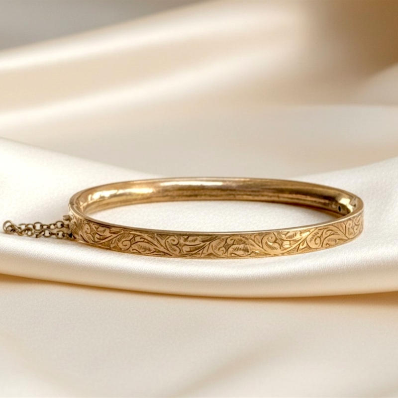 antique Edwardian rolled gold bangle on cream silk