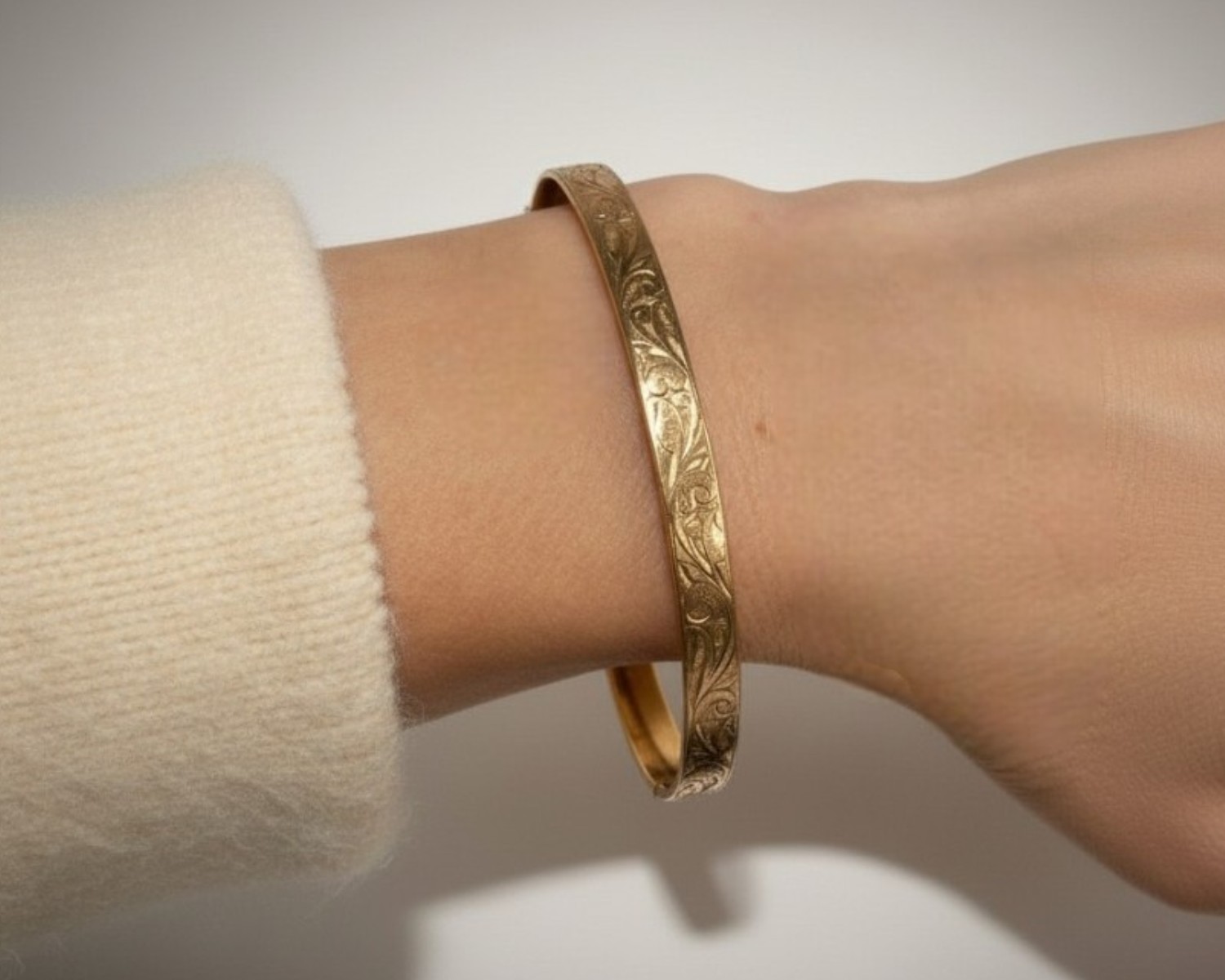 rolled gold bangle on wrist