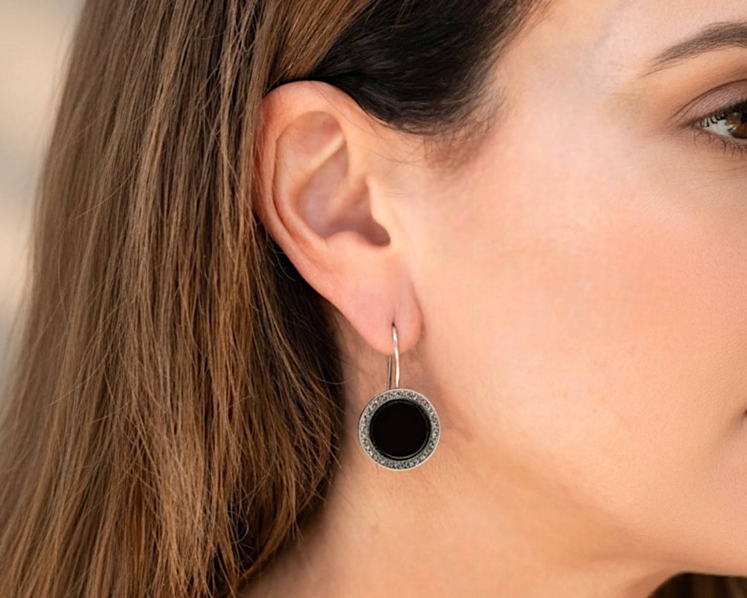 round onyx earrings on model