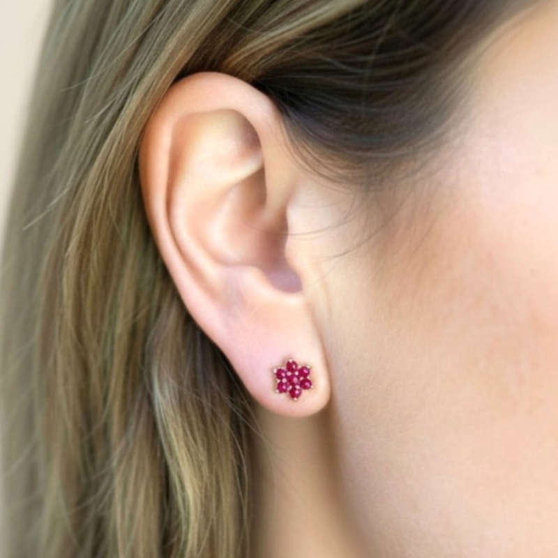 9ct god ruby floral cluster stud earrings for pierced ears for sale in Leeds, in model's ear