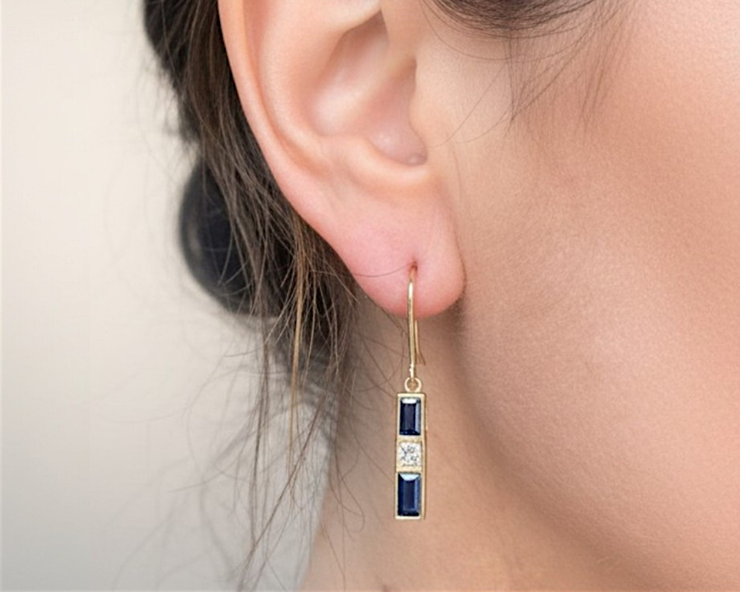 sapphire and diamond drop earrings in ear