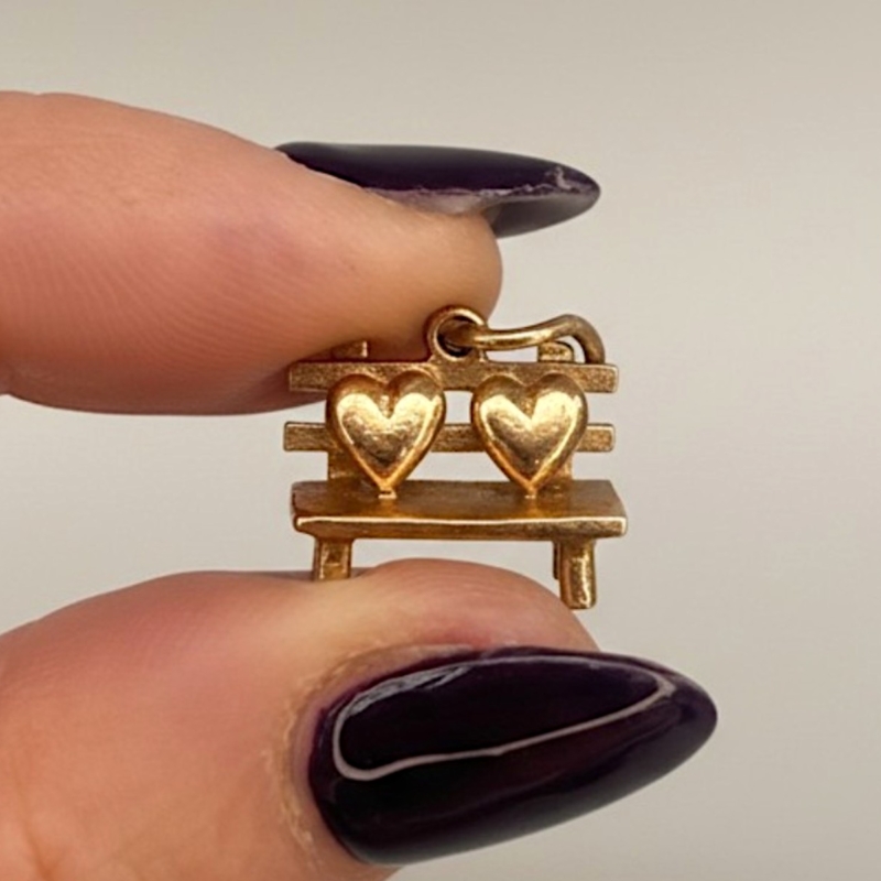 vintage 9ct gold lovers bench charm for sale between model's fingers