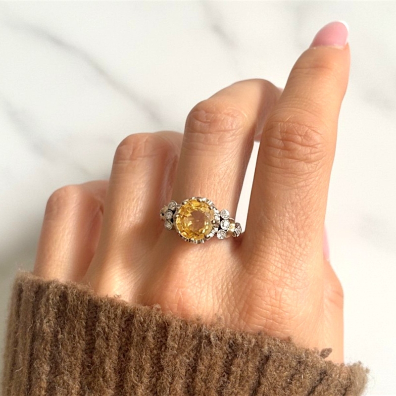 Antique 1930s yellow sapphire and diamond ring with a 6ct yellow sapphire centtre stone in platinum. For sale in Leeds, UK, shown on model's hand
