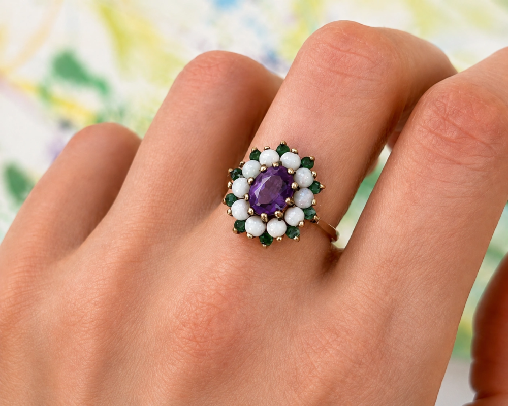 vintage amethyst, emerald and opal cluster ring in 9ct gold dated 1972. For sale in Leeds UK, shown on model's hand