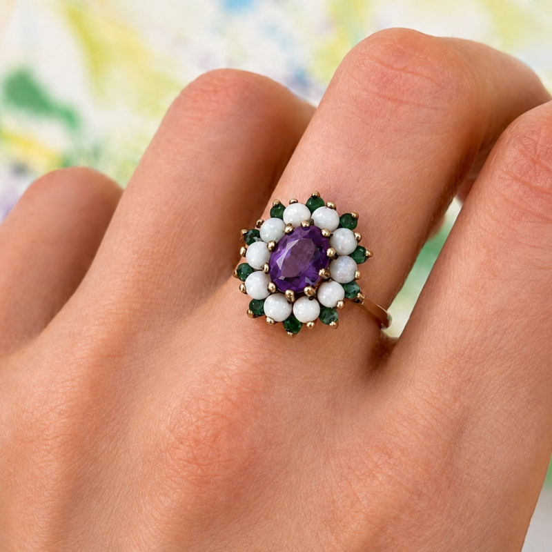 vintage amethyst, emerald and opal cluster ring in 9ct gold dated 1972. For sale in Leeds UK, shown on model's hand