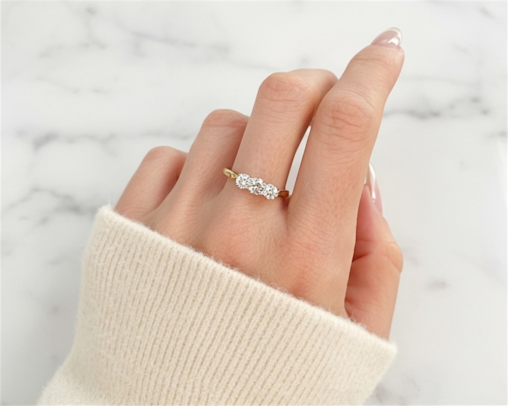 Antique 1930s diamond three stone ring in 18ct yellow gold and platinum for sale in Leeds, on model's hand