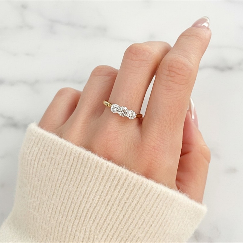 Antique 1930s diamond three stone ring in 18ct yellow gold and platinum for sale in Leeds, on model's hand