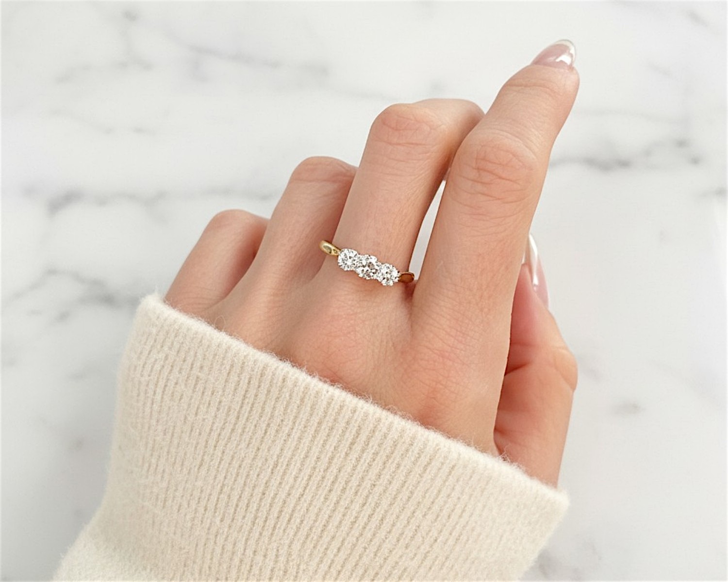 antique three stone ring on model’s hand