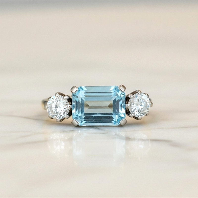 Art Deco aquamarine and diamond ring set with an emerald cut aquamarine and two round diamonds in 18ct yellow gold and platinum. For sale in Leeds, UK