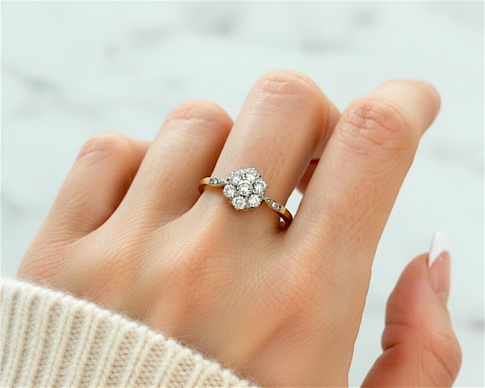 Antique Art Deco diamond cluster ring with old cut diamonds in 18ct yellow gold and platinum set, for sale in Leeds UK, shown on model's hand