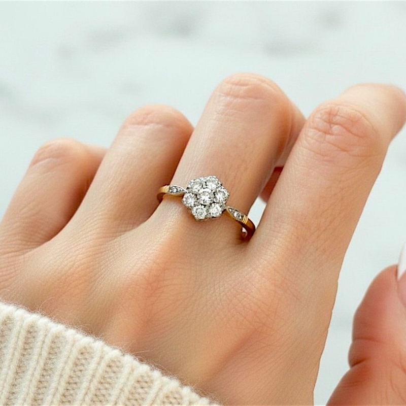 Antique Art Deco diamond cluster ring with old cut diamonds in 18ct yellow gold and platinum set, for sale in Leeds UK, shown on model's hand