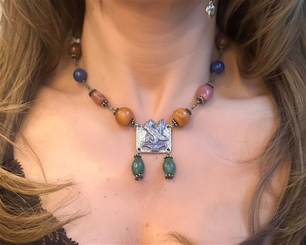 Egyptian revival silver necklace on model's neck