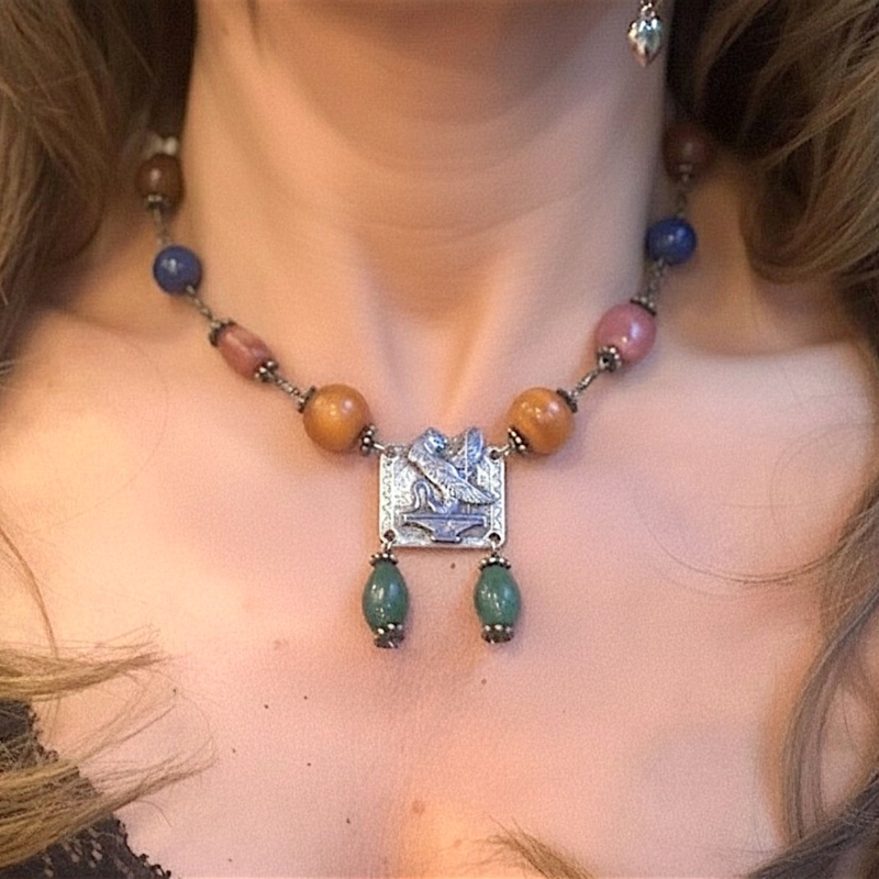 Egyptian revival silver necklace on model's neck
