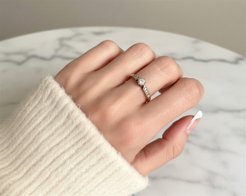 vintage diamond solitaire ring with illusion setting in 18ct yellow gold and platinum. For sale in Leeds, on model's hand