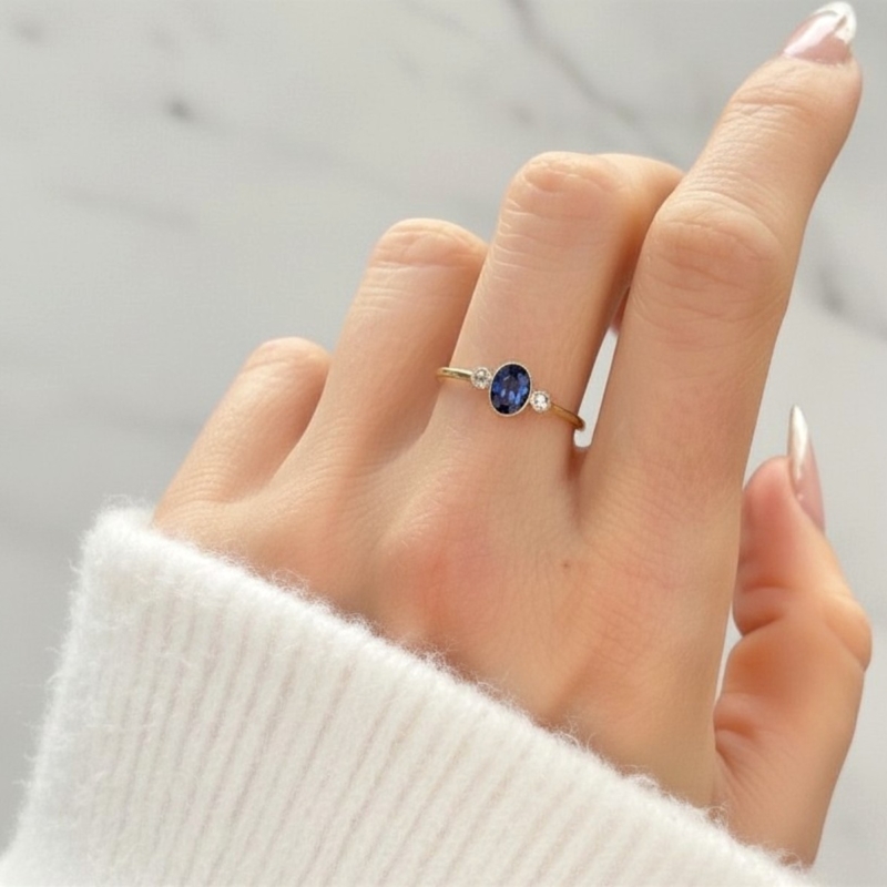 antique 1920s sapphire and diamond three stone ring in 18ct yellow gold for sale in Leeds UK on model's hand