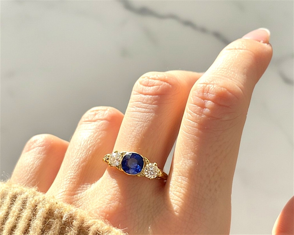 Victorian old cut diamond and blue paste ring in 18ct yellow gold for sale in Leeds, UK on model's hand