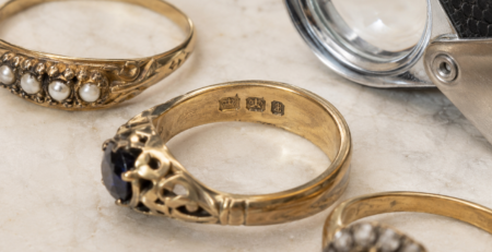 antique rings and a jeweller's eye glass