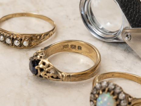 antique rings and a jeweller's eye glass