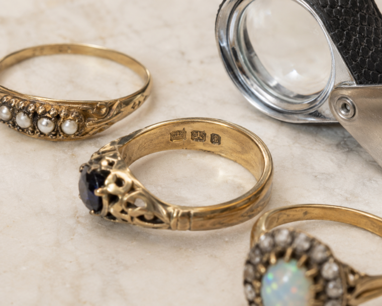 antique rings and a jeweller's eye glass