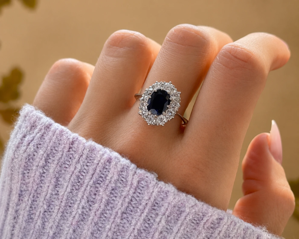 Antique Edwardian sapphire and diamond cluster ring in platinum for sale in Leeds shown on model's hand