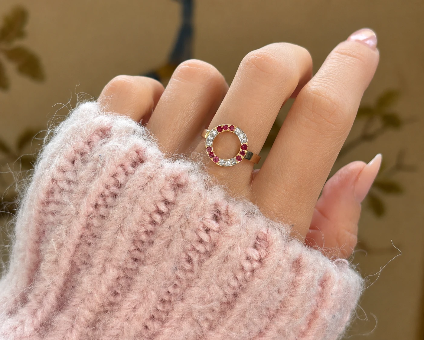 ruby halo ring on finger