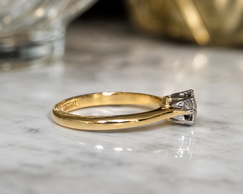 antique 1930s diamond solitaire with approx 10 points of a carat. showing side profile of the ring