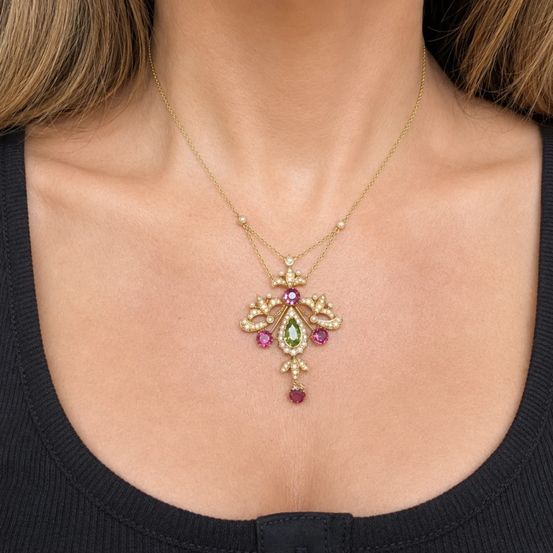 antique Edwardian suffragette necklace in 15ct gold with peridot, amethyst and seed pearl in its orginal box for sale in Leeds, shown on model's neck