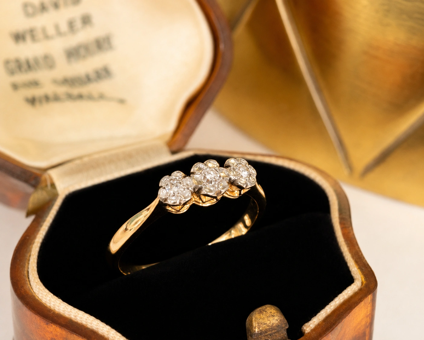 three stone cluster ring in box