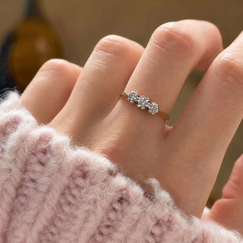 antique 1930s three stone diamond cluster ring in 18ct yellow gold and platinum for sale in Leeds, shown on model