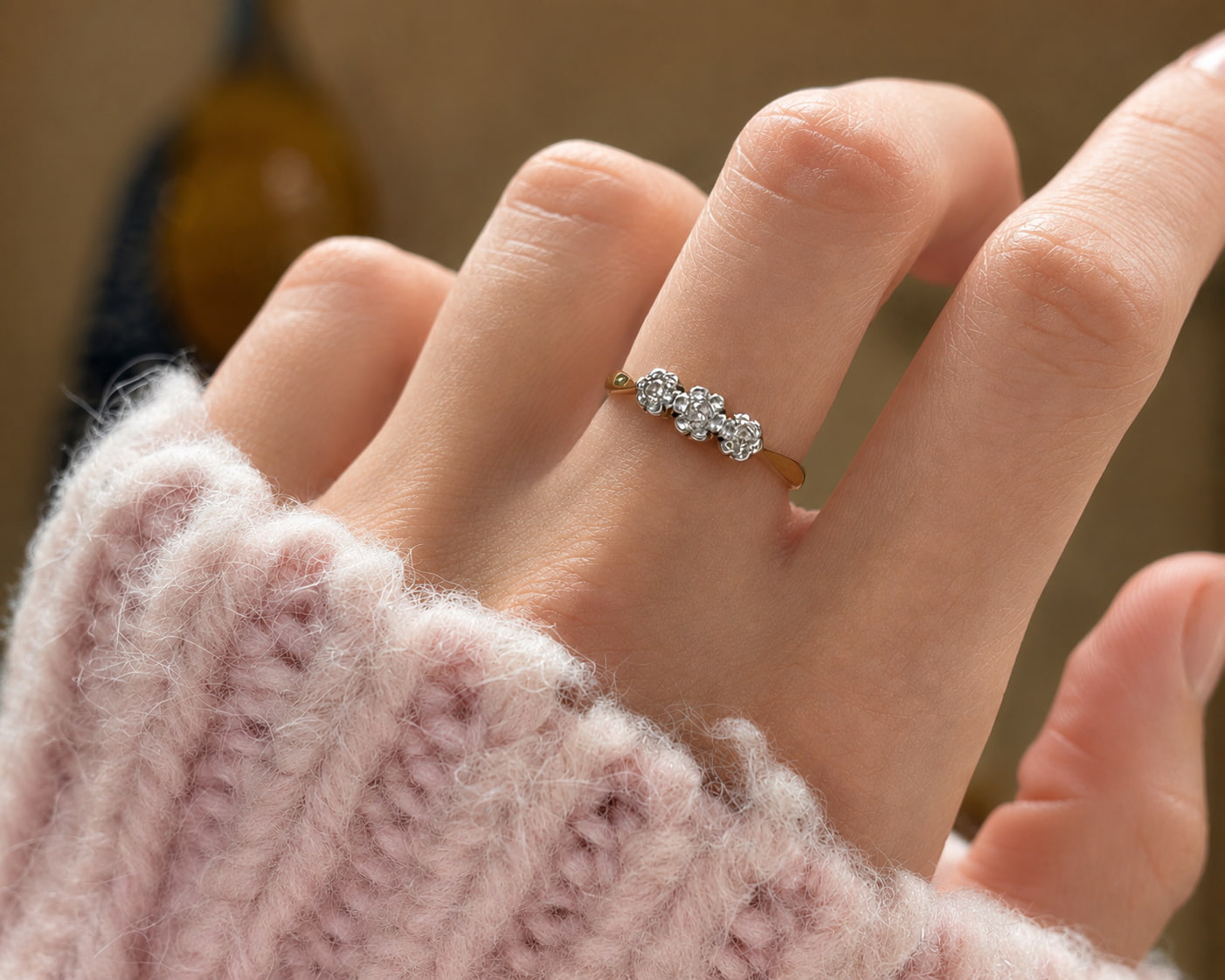 three stone cluster ring on hand