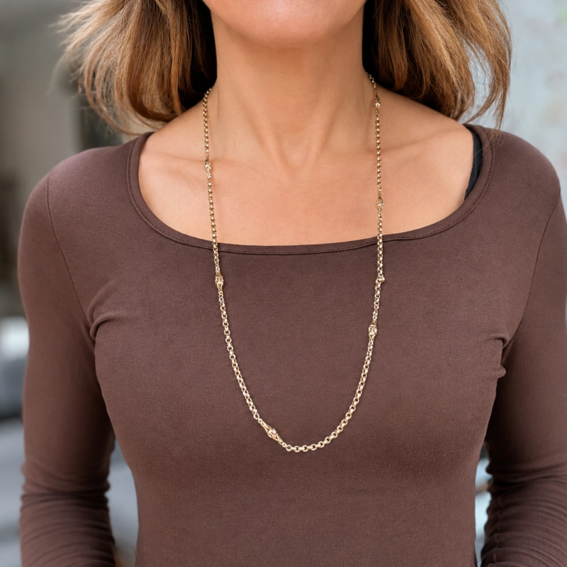 Victorian long 9ct gold chain with decorative panels for sale in Leeds shown on model