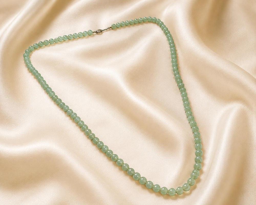1920s jade beads antique 1920s jade beads laying on silk, for sale in Leeds
