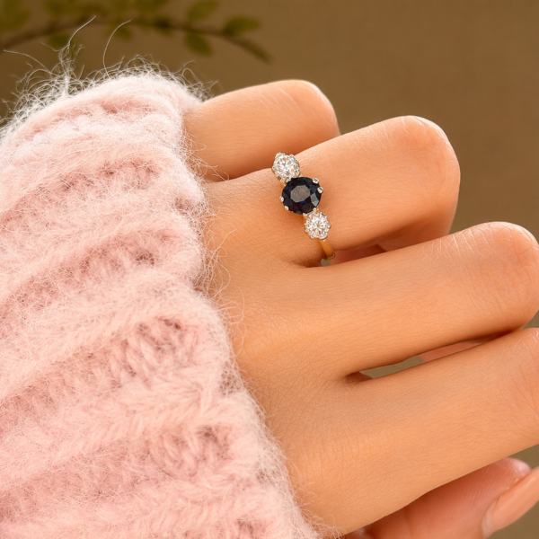 antique 1930s sapphire and diamond three stone ring in 18ct yellow gold and platinum for sale in Leeds, shown on a model's hand