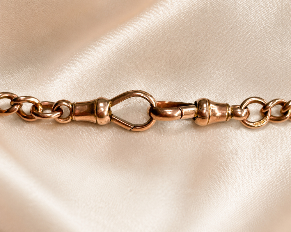 antique Edwardian 9ct gold albert chain with medal, t bar and dog clips showing the catch